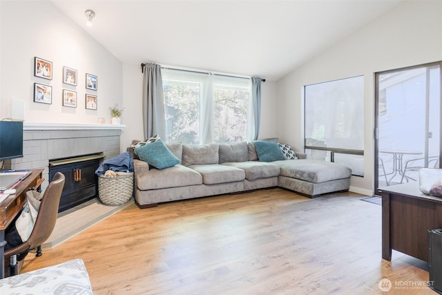 130 SW 116th St Unit F32, Seattle, WA 98146 - living area with lofted ceiling, a brick fireplace, and light wood finished floors