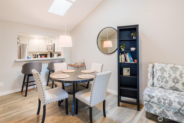 130 SW 116th St Unit F32, Seattle, WA 98146 - dining room with a skylight, light wood finished floors, lofted ceiling, and baseboards