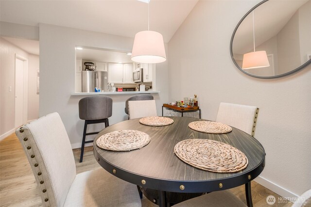 130 SW 116th St Unit F32, Seattle, WA 98146 - dining room featuring baseboards and light wood-type flooring