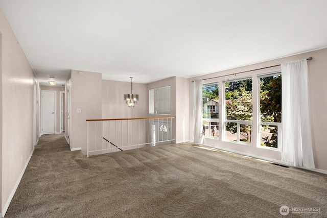 4206 SE 1st Pl, Renton, WA 98059 - unfurnished room with carpet flooring, a chandelier, and baseboards