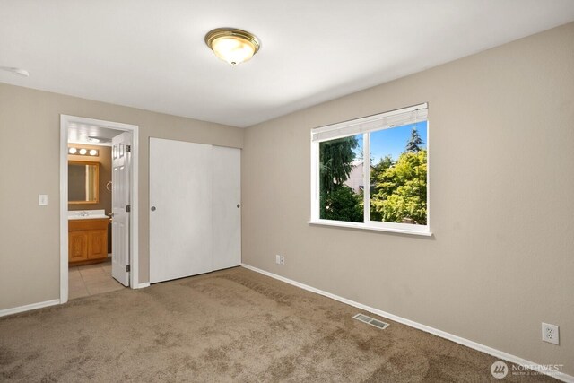 4206 SE 1st Pl, Renton, WA 98059 - unfurnished bedroom with light colored carpet, baseboards, ensuite bathroom, and a closet
