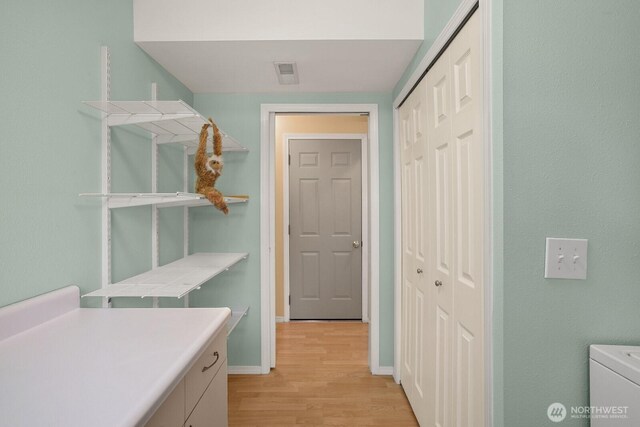 4206 SE 1st Pl, Renton, WA 98059 - laundry area featuring light wood-type flooring, baseboards, and washer / clothes dryer