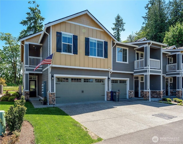 8713 E Gilman Ave, Arlington, WA 98223 - view of front of home with stone siding, an attached garage, driveway, a balcony, and board and batten siding