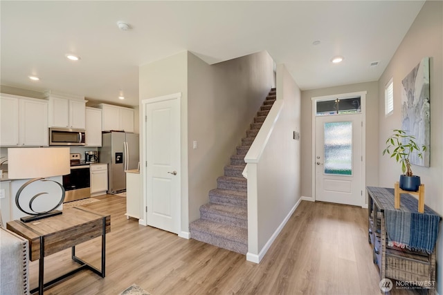 8713 E Gilman Ave, Arlington, WA 98223 - entryway with light wood-style flooring, stairway, baseboards, and recessed lighting