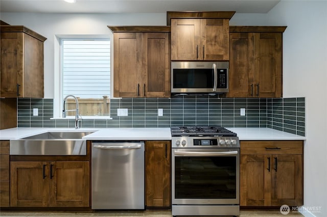 14516 204th Ave E Unit 895, Bonney Lake, WA 98391 - kitchen with stainless steel appliances, a sink, tasteful backsplash, and light countertops