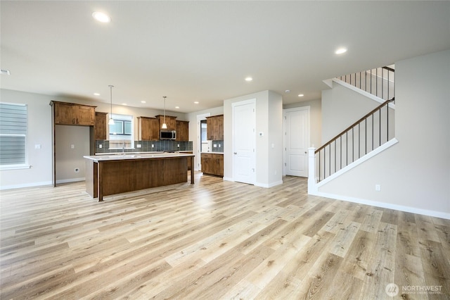 14516 204th Ave E Unit 895, Bonney Lake, WA 98391 - kitchen featuring open floor plan, stainless steel microwave, tasteful backsplash, recessed lighting, and light countertops