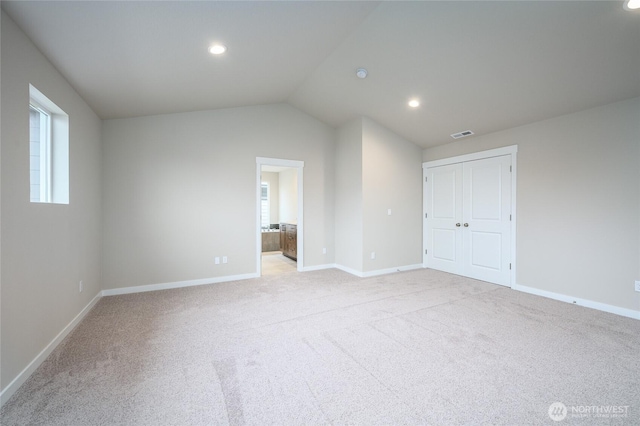 14516 204th Ave E Unit 895, Bonney Lake, WA 98391 - unfurnished bedroom with baseboards, light carpet, recessed lighting, lofted ceiling, and ensuite bath