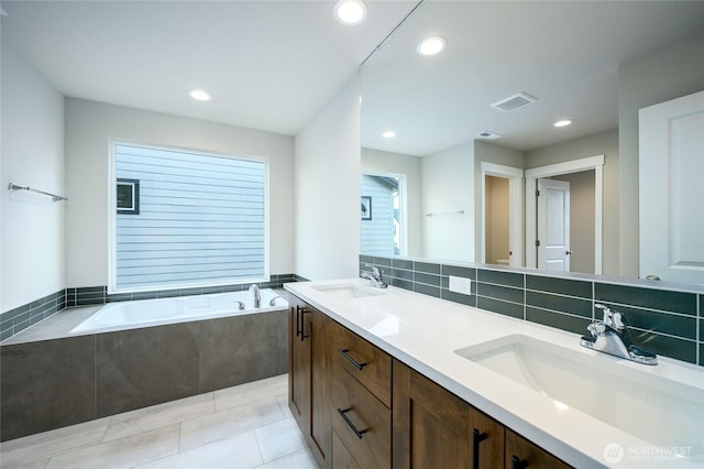 14516 204th Ave E Unit 895, Bonney Lake, WA 98391 - bathroom featuring a garden tub, double vanity, recessed lighting, tile patterned floors, and tasteful backsplash