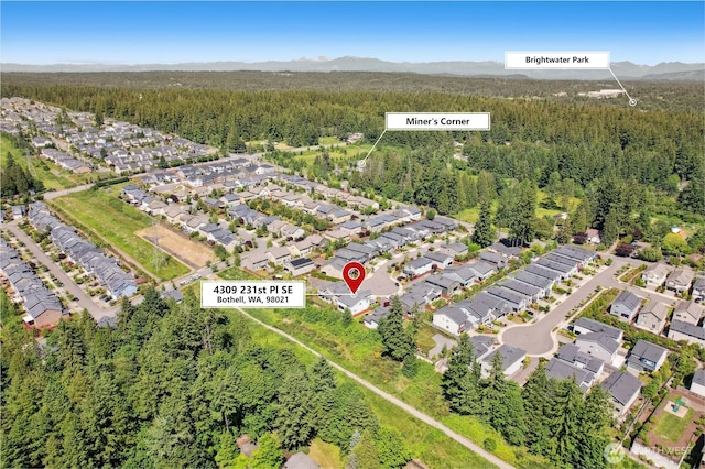 4309 231st Pl SE, Bothell, WA 98021 - aerial view of property and surrounding area featuring a forest and nearby suburban area