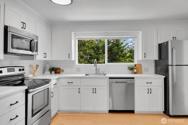 15226 116th Pl NE, Kirkland, WA 98034 - kitchen with stainless steel appliances, backsplash, crown molding, light countertops, and white cabinetry