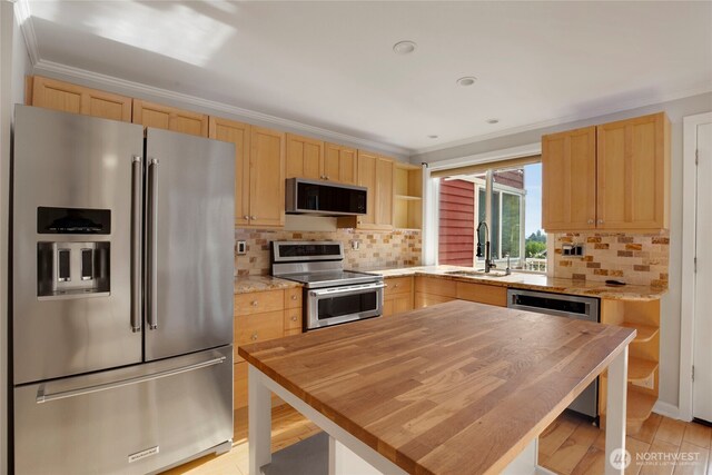 2400 E Howell St Unit G, Seattle, WA 98122 - kitchen with appliances with stainless steel finishes, light brown cabinets, butcher block countertops, a sink, and crown molding