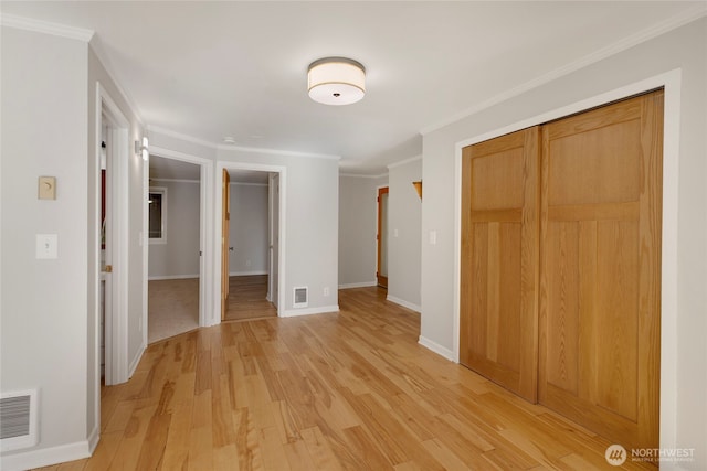 2400 E Howell St Unit G, Seattle, WA 98122 - unfurnished bedroom featuring a closet, light wood finished floors, baseboards, and ornamental molding