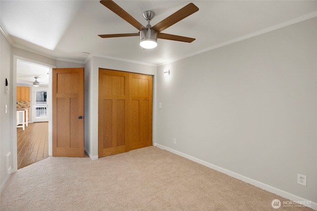2400 E Howell St Unit G, Seattle, WA 98122 - unfurnished bedroom with carpet floors, baseboards, ornamental molding, ceiling fan, and a closet