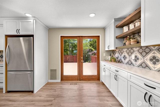 801 38th St, Bellingham, WA 98229 - kitchen with freestanding refrigerator, open shelves, french doors, light wood finished floors, and recessed lighting