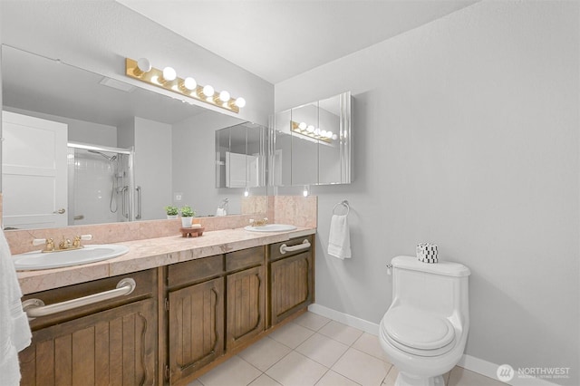 801 38th St, Bellingham, WA 98229 - full bath with tile patterned floors, double vanity, a shower stall, baseboards, and toilet