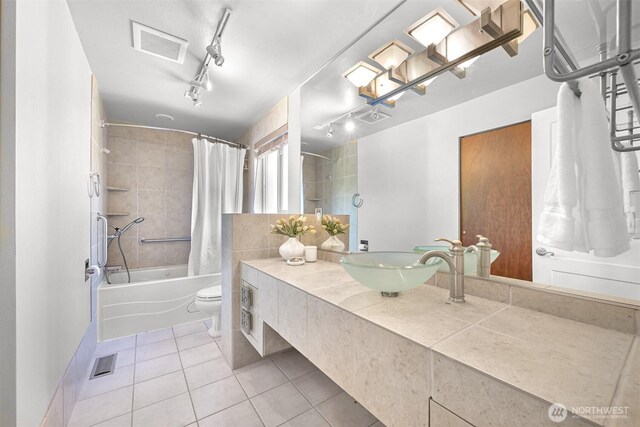 801 38th St, Bellingham, WA 98229 - full bathroom featuring tile patterned floors, shower / bath combo with shower curtain, vanity, toilet, and track lighting