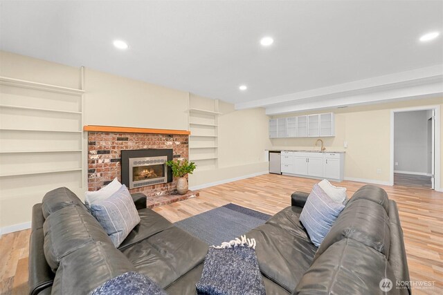801 38th St, Bellingham, WA 98229 - living room featuring baseboards, light wood finished floors, recessed lighting, a fireplace, and built in features