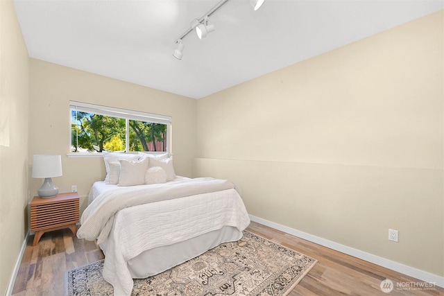 801 38th St, Bellingham, WA 98229 - bedroom featuring wood finished floors, baseboards, and rail lighting