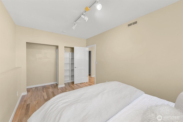 801 38th St, Bellingham, WA 98229 - bedroom with wood finished floors, baseboards, a closet, and rail lighting