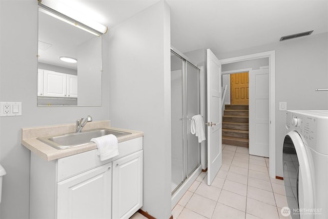 801 38th St, Bellingham, WA 98229 - full bath with washer / dryer, vanity, a stall shower, and tile patterned floors