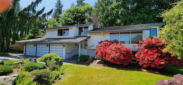10622 44th Ave SE, Everett, WA 98208 - view of front of house with a chimney, a front lawn, driveway, and a garage