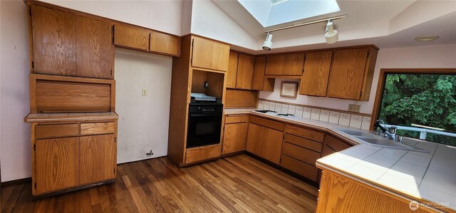 10622 44th Ave SE, Everett, WA 98208 - kitchen featuring tile countertops, black oven, a skylight, dark wood-style floors, and a sink