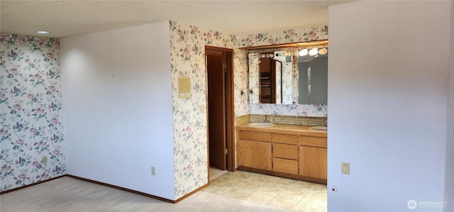 10622 44th Ave SE, Everett, WA 98208 - full bath with wallpapered walls, double vanity, a textured ceiling, and baseboards