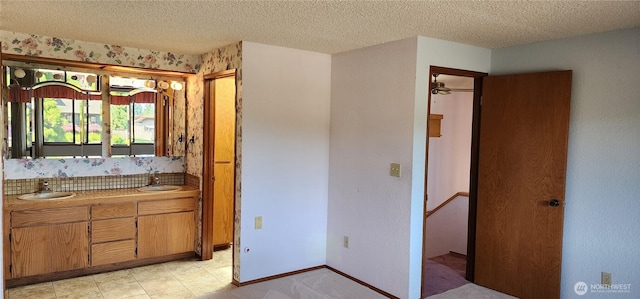 10622 44th Ave SE, Everett, WA 98208 - bathroom featuring a textured ceiling, double vanity, and baseboards