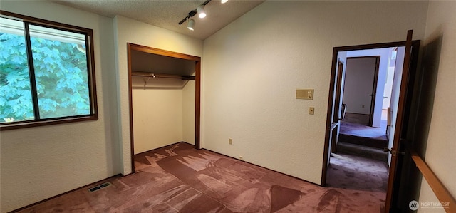 10622 44th Ave SE, Everett, WA 98208 - unfurnished bedroom featuring carpet, a textured wall, multiple windows, a closet, and a textured ceiling