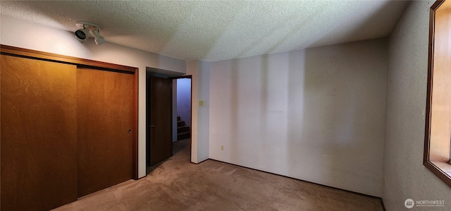 10622 44th Ave SE, Everett, WA 98208 - unfurnished bedroom with carpet floors, a textured ceiling, and a closet