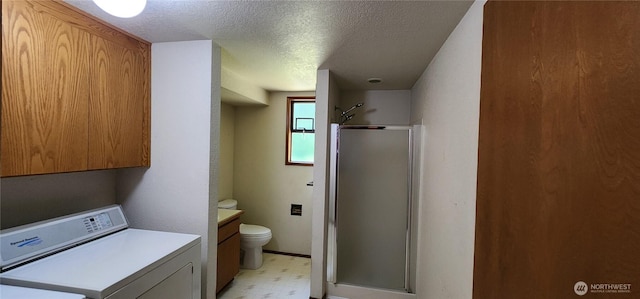 10622 44th Ave SE, Everett, WA 98208 - full bathroom with washer / clothes dryer, tile patterned floors, toilet, a shower stall, and a textured ceiling