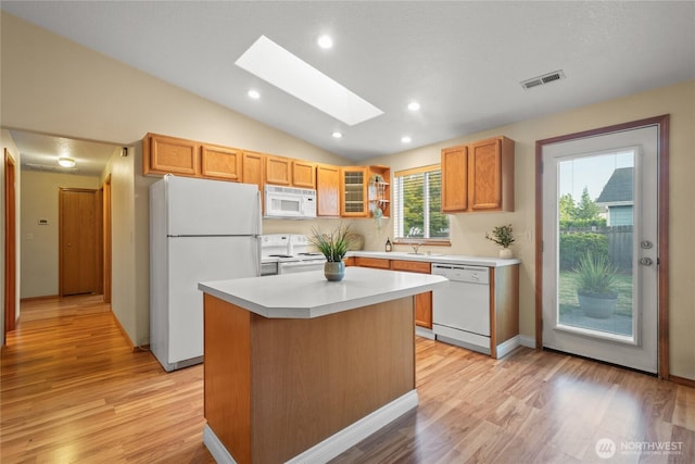 16215 NE 13th St, Vancouver, WA 98684 - kitchen featuring white appliances, light wood finished floors, a skylight, a kitchen island, and light countertops