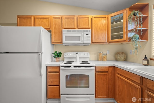 16215 NE 13th St, Vancouver, WA 98684 - kitchen featuring white appliances, lofted ceiling, light countertops, and glass insert cabinets