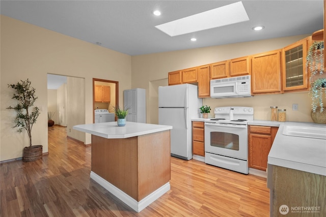 16215 NE 13th St, Vancouver, WA 98684 - kitchen with white appliances, a skylight, washer / clothes dryer, light wood-type flooring, and recessed lighting