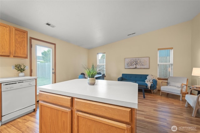 16215 NE 13th St, Vancouver, WA 98684 - kitchen with white dishwasher, open floor plan, vaulted ceiling, light wood-style floors, and light countertops