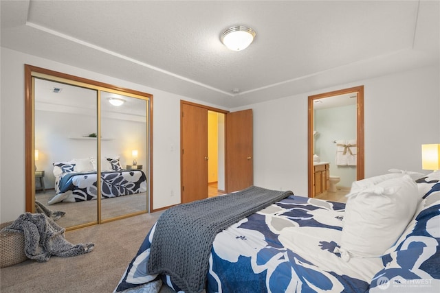 16215 NE 13th St, Vancouver, WA 98684 - bedroom with light colored carpet, a closet, a tray ceiling, ensuite bath, and a textured ceiling