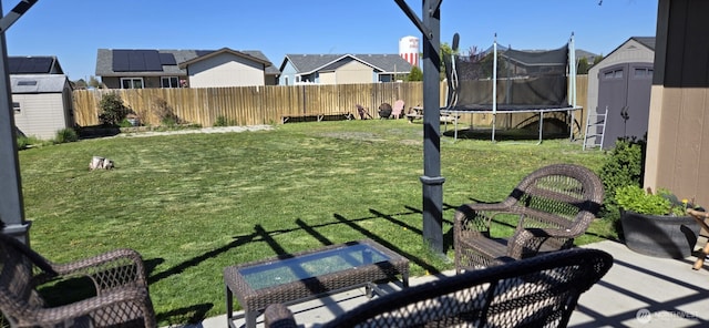 1175 E Cypress St, Othello, WA 99344 - view of yard featuring a trampoline, a residential view, and a patio