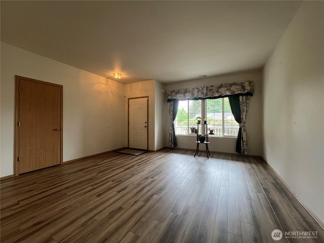 15121 148th St E, Orting, WA 98360 - unfurnished living room featuring dark wood-type flooring