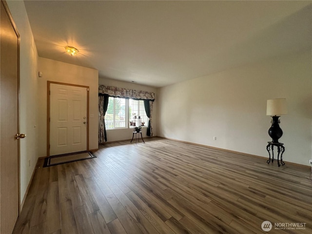 15121 148th St E, Orting, WA 98360 - unfurnished living room featuring dark wood-style floors and baseboards