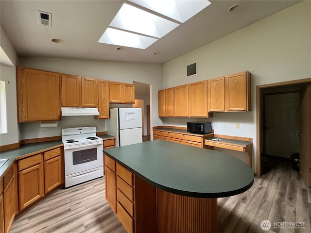 15121 148th St E, Orting, WA 98360 - kitchen featuring white appliances, under cabinet range hood, a skylight, light wood-type flooring, and a center island