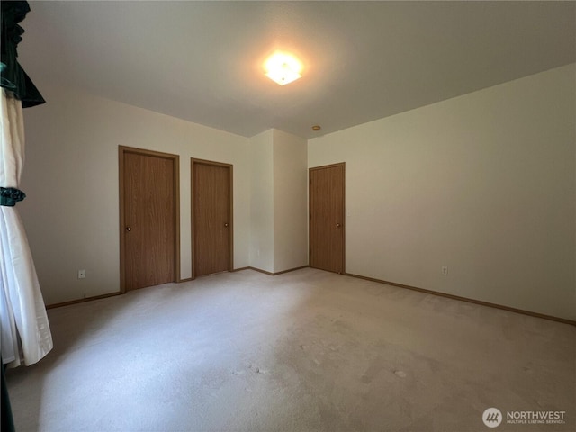 15121 148th St E, Orting, WA 98360 - unfurnished bedroom featuring two closets and baseboards