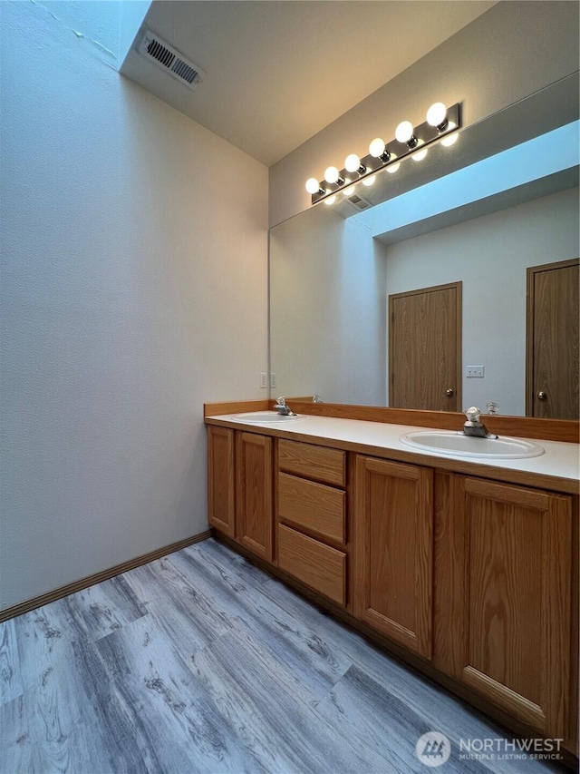 15121 148th St E, Orting, WA 98360 - bathroom with double vanity and wood finished floors