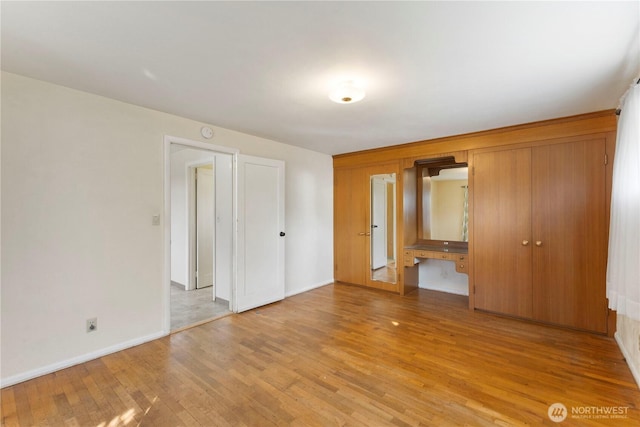 3804 Olympic Blvd W, University Place, WA 98466 - unfurnished bedroom featuring light wood-type flooring, baseboards, and a closet