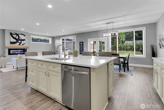 10617 Rosewood Ave Unit A, Everett, WA 98204 - kitchen featuring dishwasher, a sink, light countertops, a glass covered fireplace, and recessed lighting
