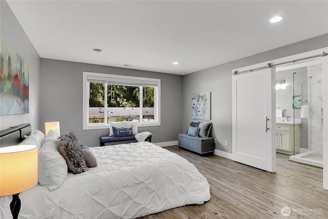 10617 Rosewood Ave Unit A, Everett, WA 98204 - bedroom with a barn door, light wood finished floors, recessed lighting, baseboards, and a sink