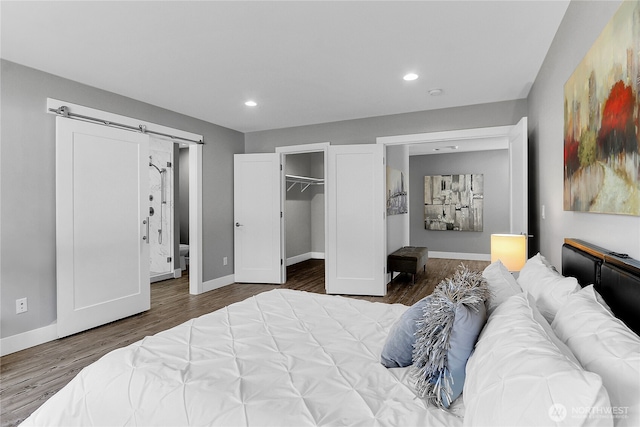 10617 Rosewood Ave Unit A, Everett, WA 98204 - bedroom with a barn door, wood finished floors, baseboards, recessed lighting, and a spacious closet