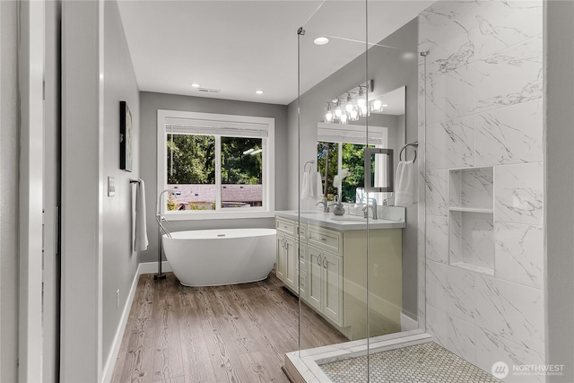 10617 Rosewood Ave Unit A, Everett, WA 98204 - full bathroom with vanity, a freestanding tub, healthy amount of natural light, wood finished floors, and recessed lighting
