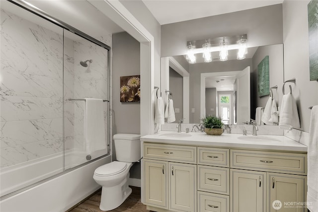 10617 Rosewood Ave Unit A, Everett, WA 98204 - full bath with toilet, double vanity, enclosed tub / shower combo, and wood finished floors