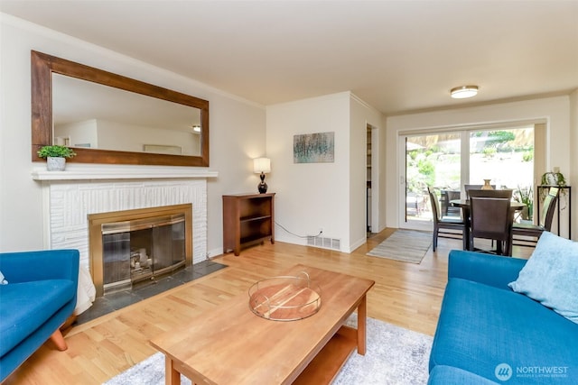 11258 29th Ave SW, Seattle, WA 98146 - living area featuring wood finished floors, a fireplace, and baseboards