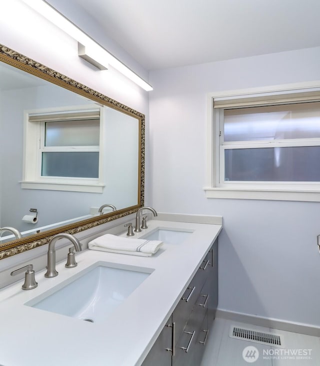11258 29th Ave SW, Seattle, WA 98146 - bathroom featuring double vanity, baseboards, and tile patterned floors